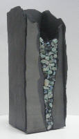 a 12 inch tall slate vase with emeralds