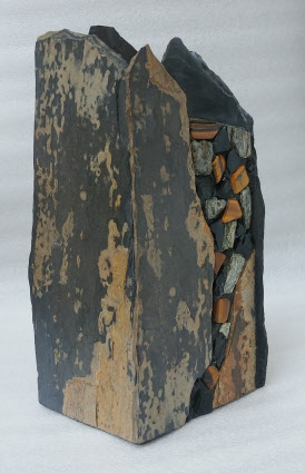 A natural stone vase with tiger's eye and obsidian
